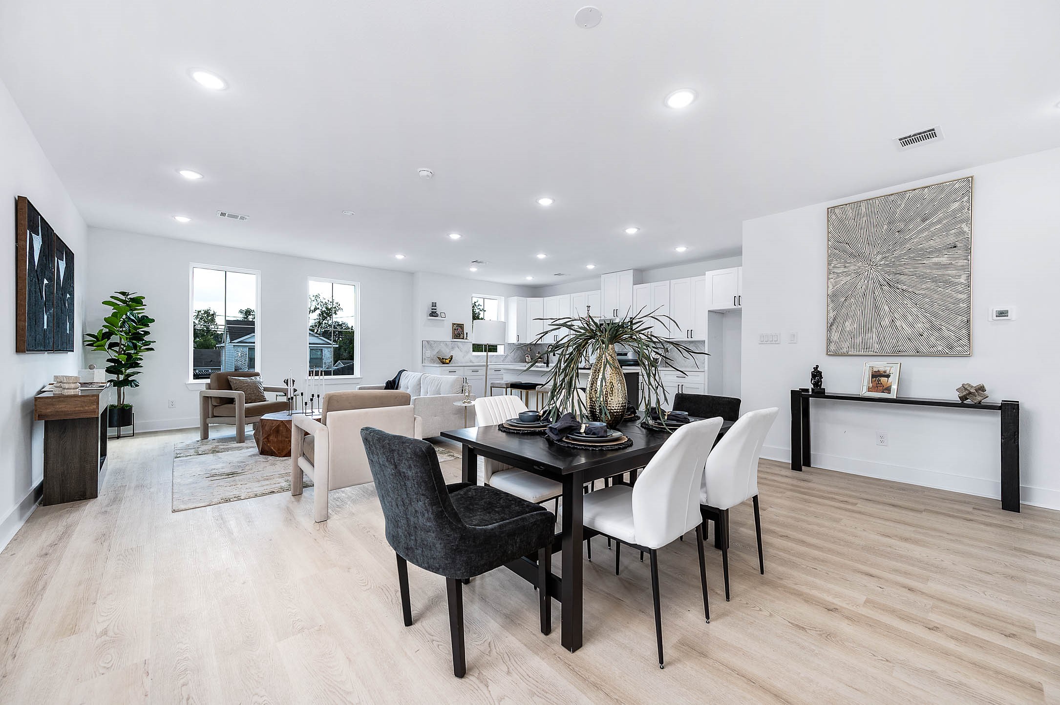 1515 Euel Street Houston, TX 77009 - Photo 9 of 34 Beautiful dining and living area where expansive windows and light wood flooring enhance the home’s bright and modern feel.