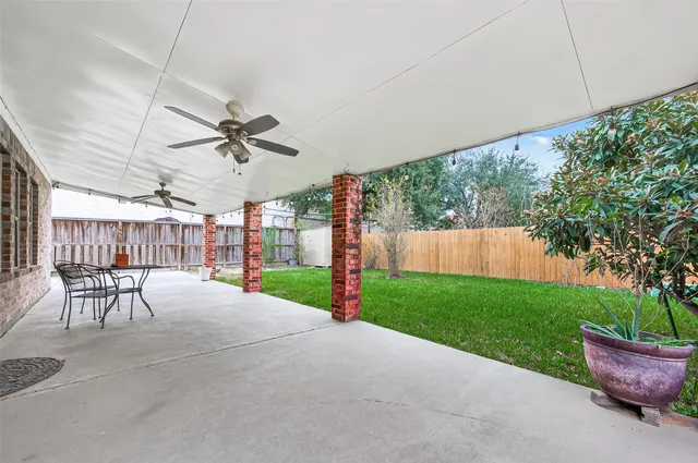 a view of a patio with a table and chairs