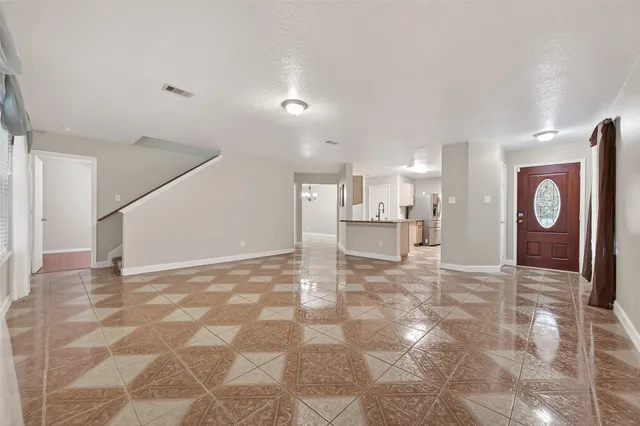 a view of a livingroom with furniture and an entryway