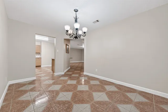 a view of a hallway with a chandelier