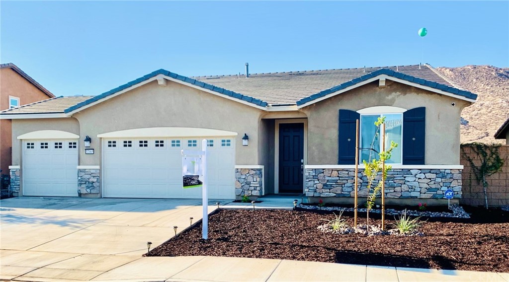 Newly landscaped front yard.  Three car garage!