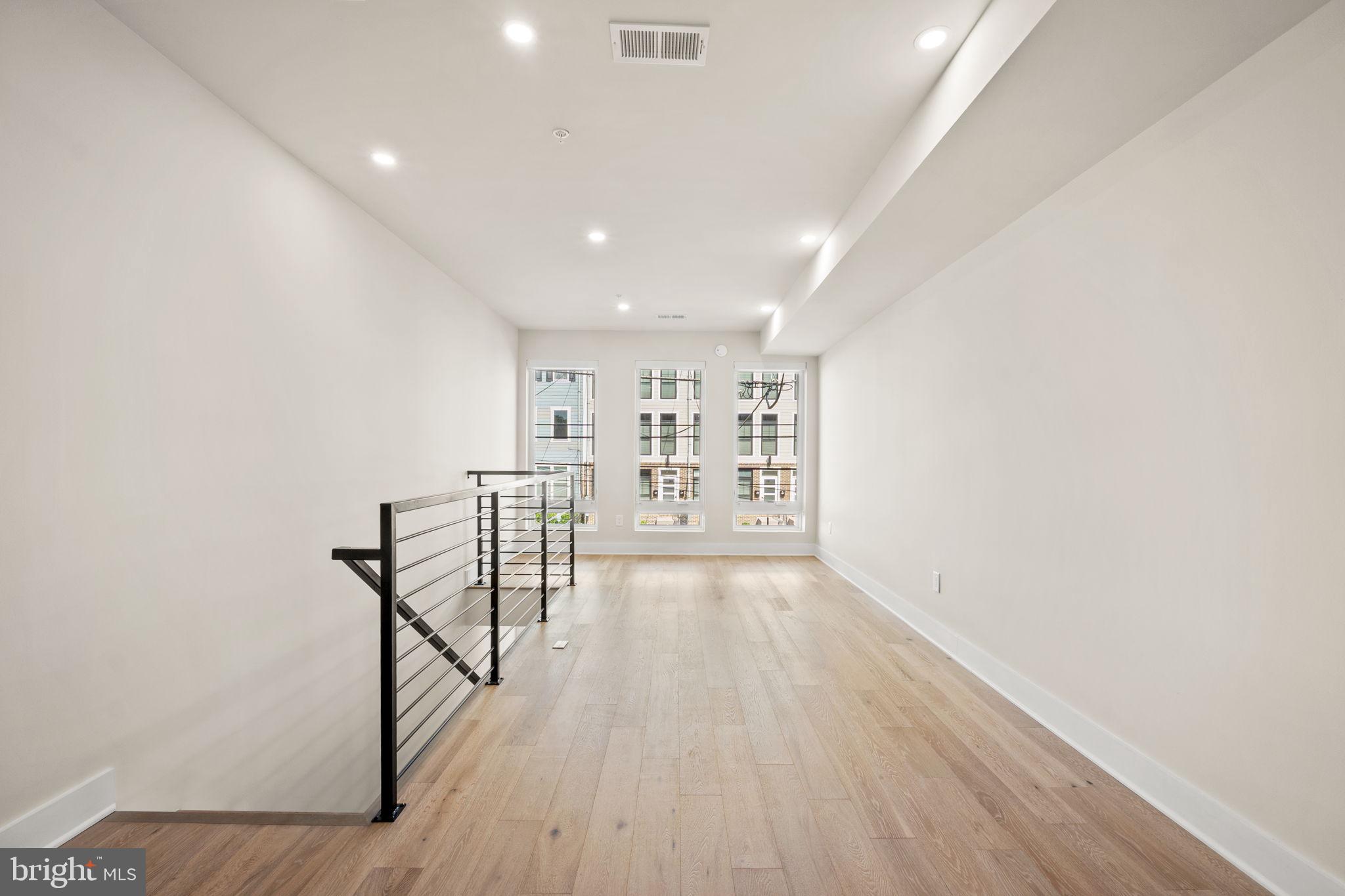 1923 Capitol Avenue Northeast, Unit 2 Washington, DC 20002 - Photo 11 of 32 a view of an empty room with wooden floor and a window