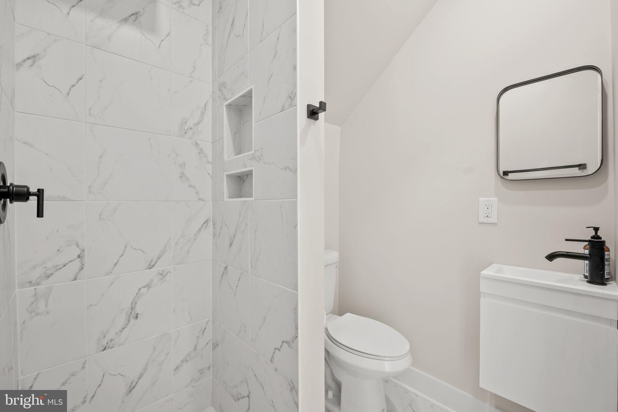 1923 Capitol Avenue Northeast, Unit 2 Washington, DC 20002 - Photo 13 of 32 a bathroom with a toilet sink and vanity