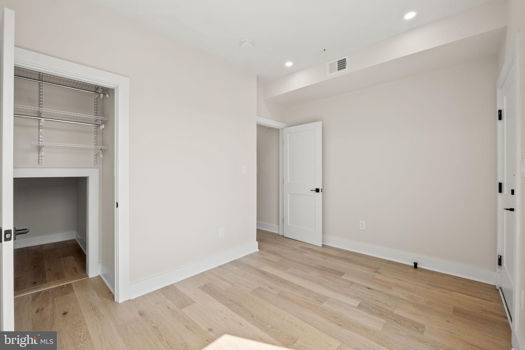 1923 Capitol Avenue Northeast, Unit 2 Washington, DC 20002 - Photo 16 of 32 a view of an empty room with wooden floor and closet