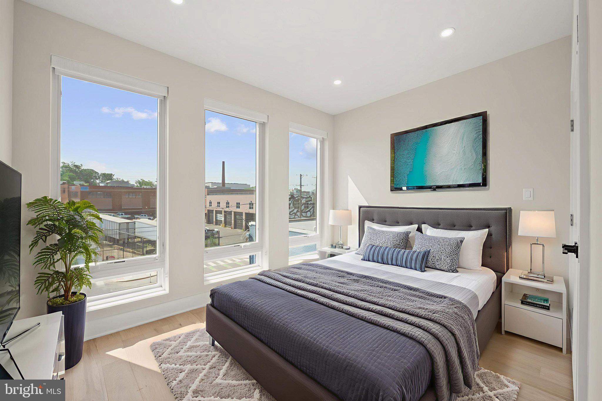 1923 Capitol Avenue Northeast, Unit 2 Washington, DC 20002 - Photo 18 of 32 a bedroom with a bed and a potted plant