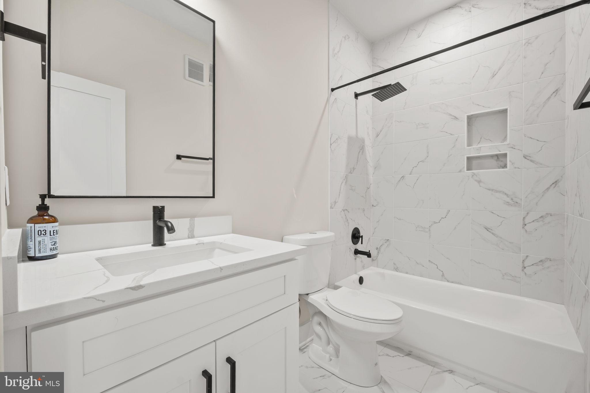 1923 Capitol Avenue Northeast, Unit 2 Washington, DC 20002 - Photo 20 of 32 a bathroom with a sink a toilet and a bathtub