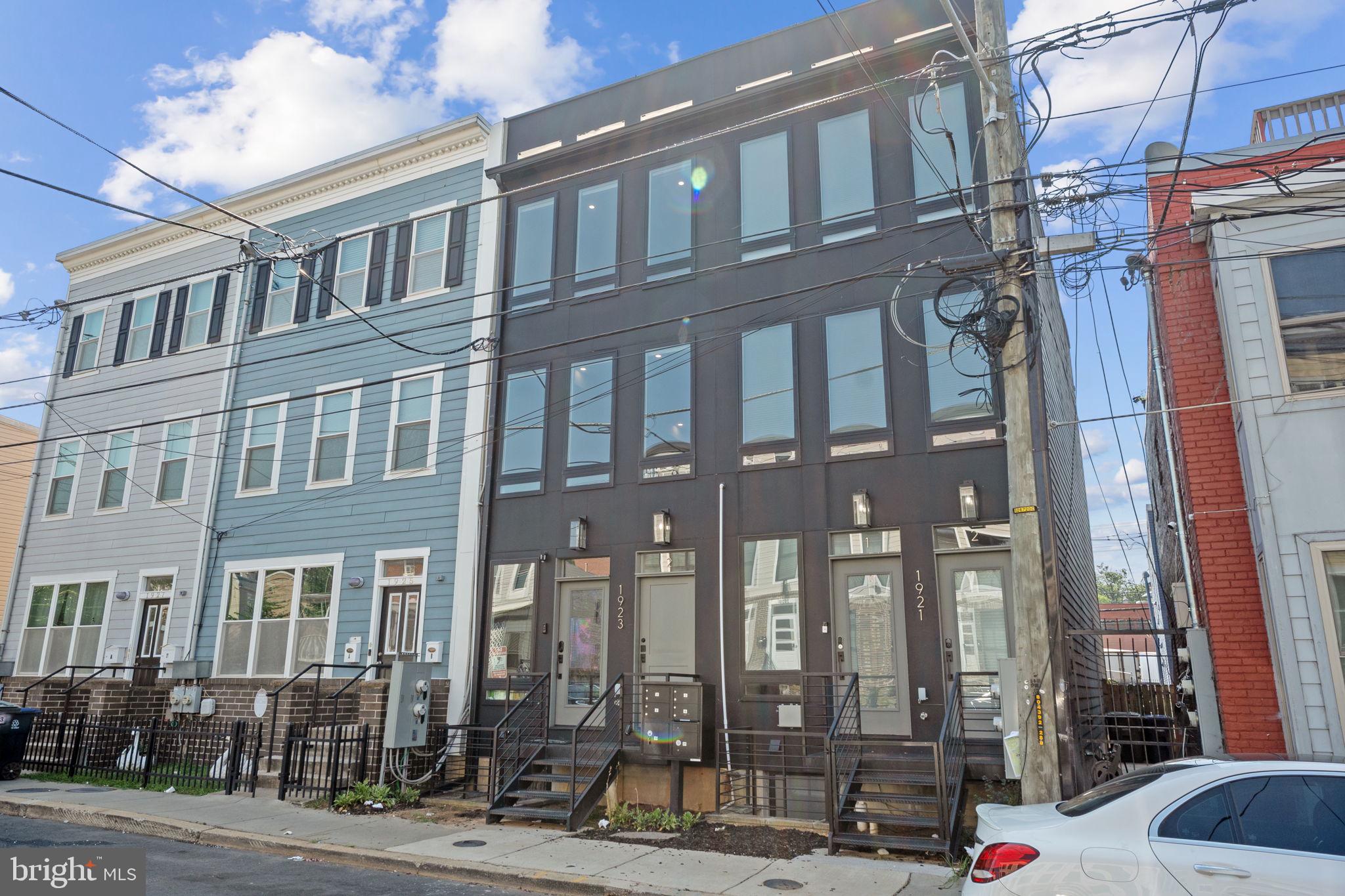 1923 Capitol Avenue Northeast, Unit 2 Washington, DC 20002 - Photo 4 of 32 a city street lined with tall buildings