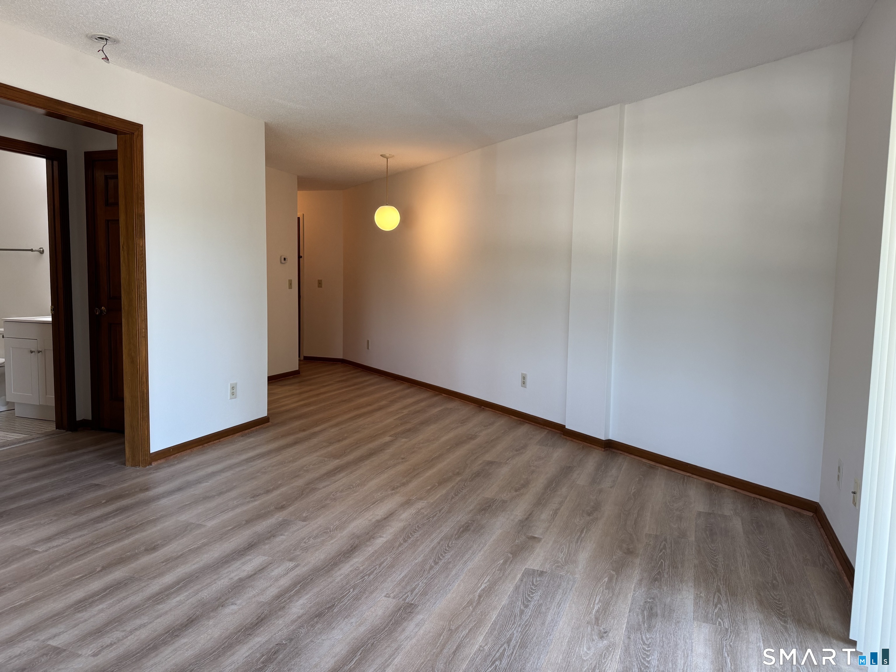 1022 Main Street, Unit 7 Branford, CT 06405 - Photo 3 of 10 a view of empty room with wooden floor