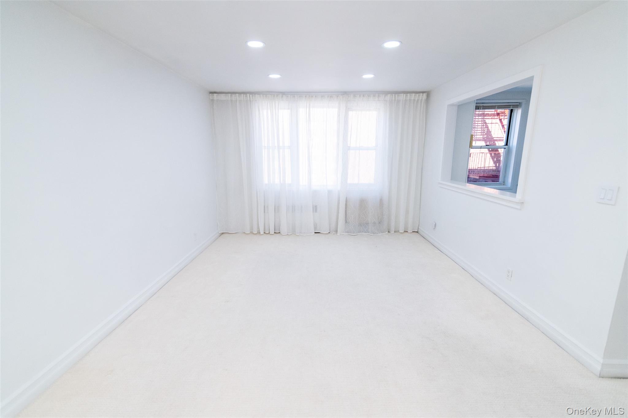 1 Sadore Lane, Unit 5A Yonkers, NY 10710 - Photo 2 of 23 an empty room with windows