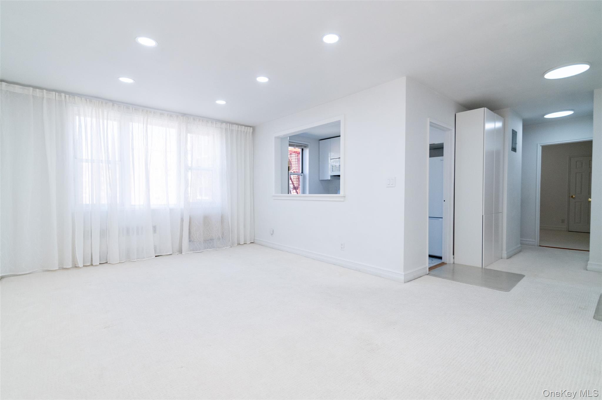 1 Sadore Lane, Unit 5A Yonkers, NY 10710 - Photo 3 of 23 an empty room with windows and closet