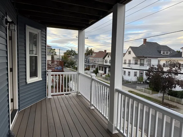 a view of a balcony with a floor to ceiling window wooden floor