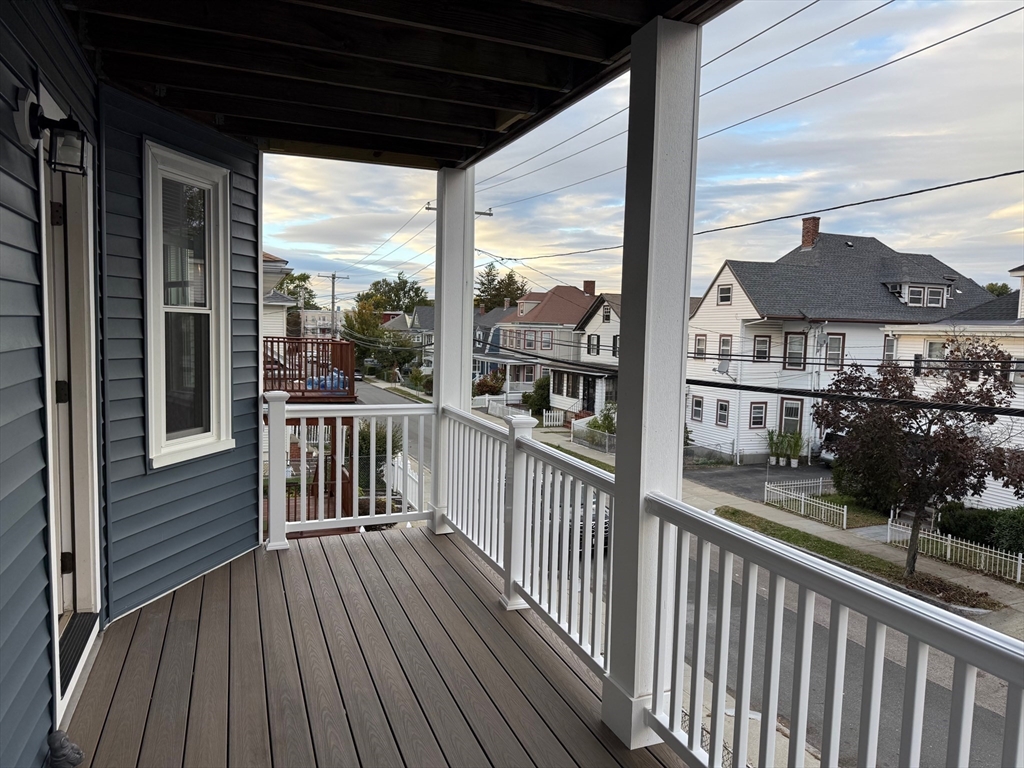 39 Rawson Road, Unit 2 Quincy, MA 02170 - Photo 1 of 6 a view of a balcony with a floor to ceiling window wooden floor
