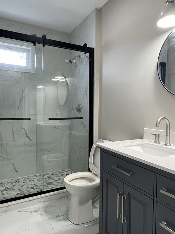 39 Rawson Road, Unit 2 Quincy, MA 02170 - Photo 4 of 6 a bathroom with a sink a toilet and shower