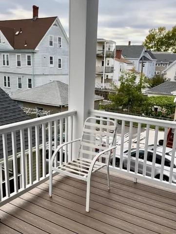 a view of a balcony with wooden floor