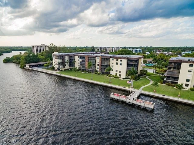 an aerial view of a house with a yard and lake view