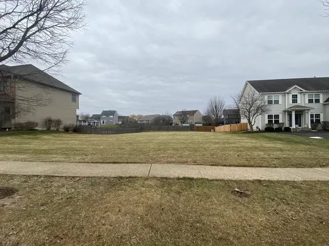 a view of building with yard and ocean view