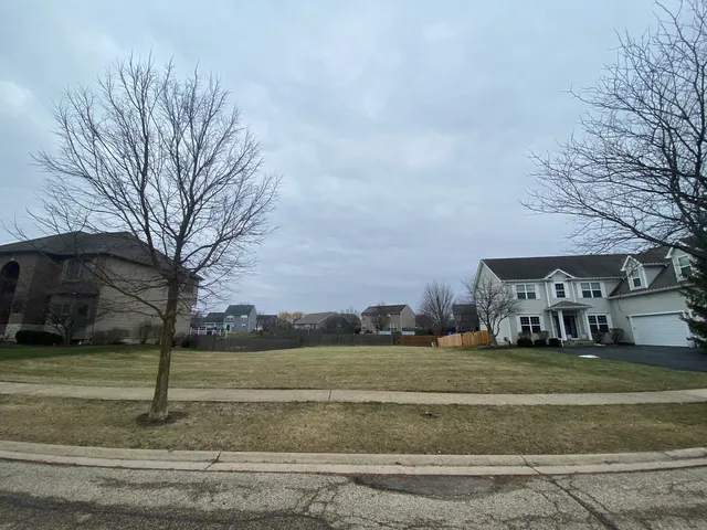 a view of a field with houses