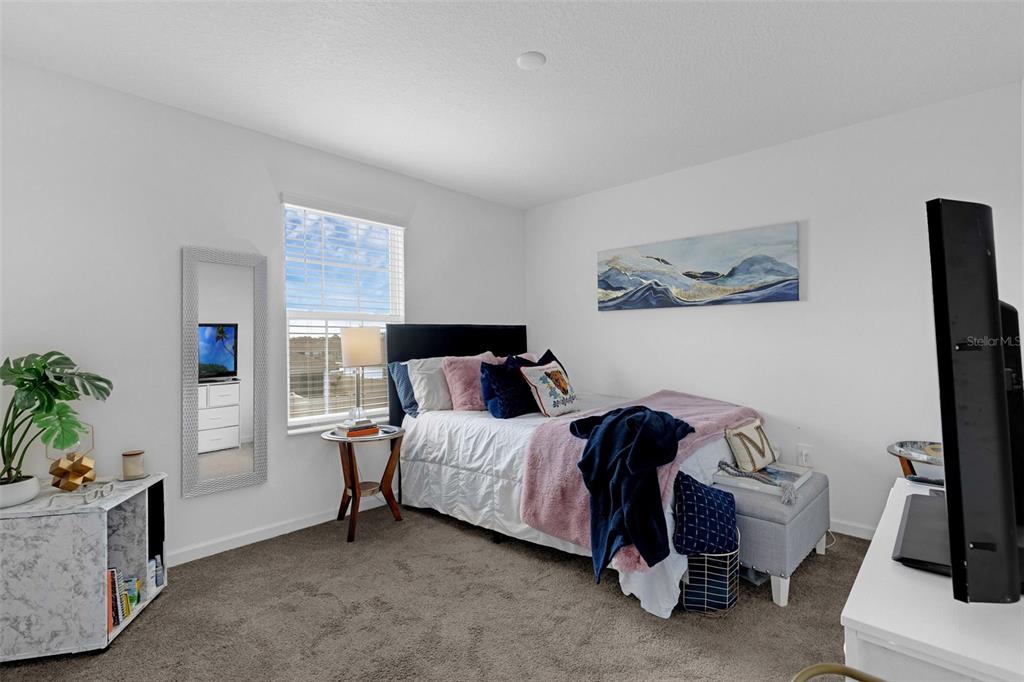 34535 Shellback Street Leesburg, FL 34788 - Photo 21 of 36 a bedroom with a bed and a couch