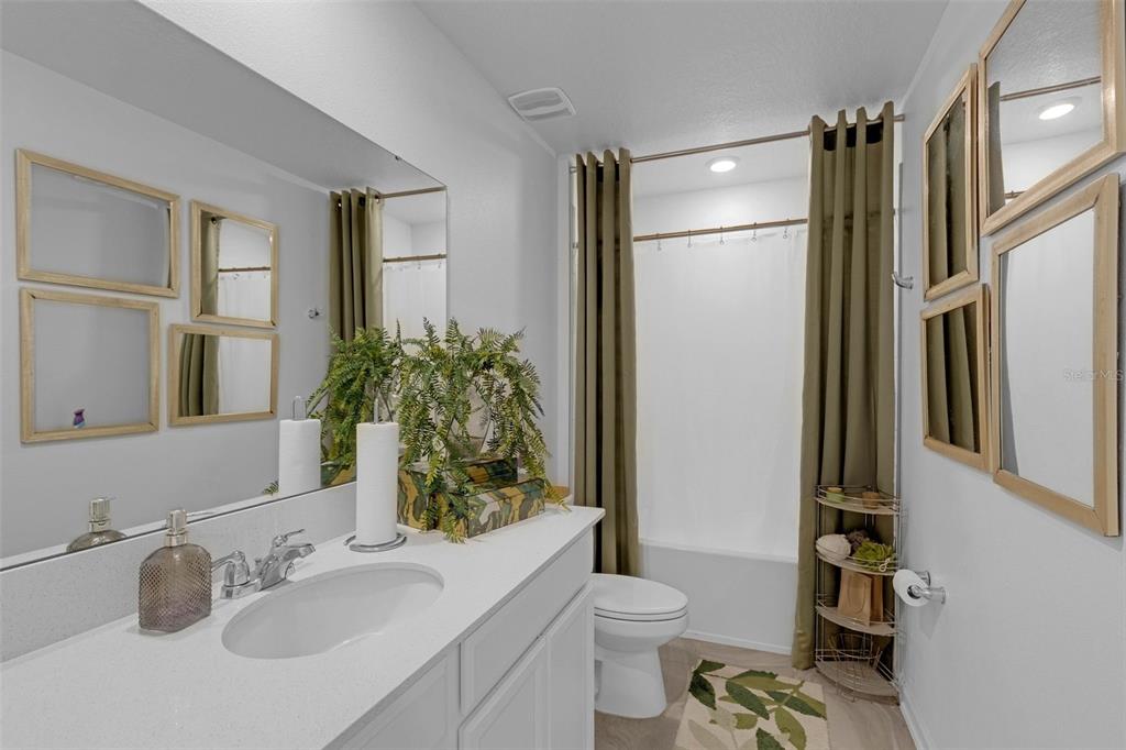 34535 Shellback Street Leesburg, FL 34788 - Photo 31 of 36 a bathroom with a sink toilet and shower