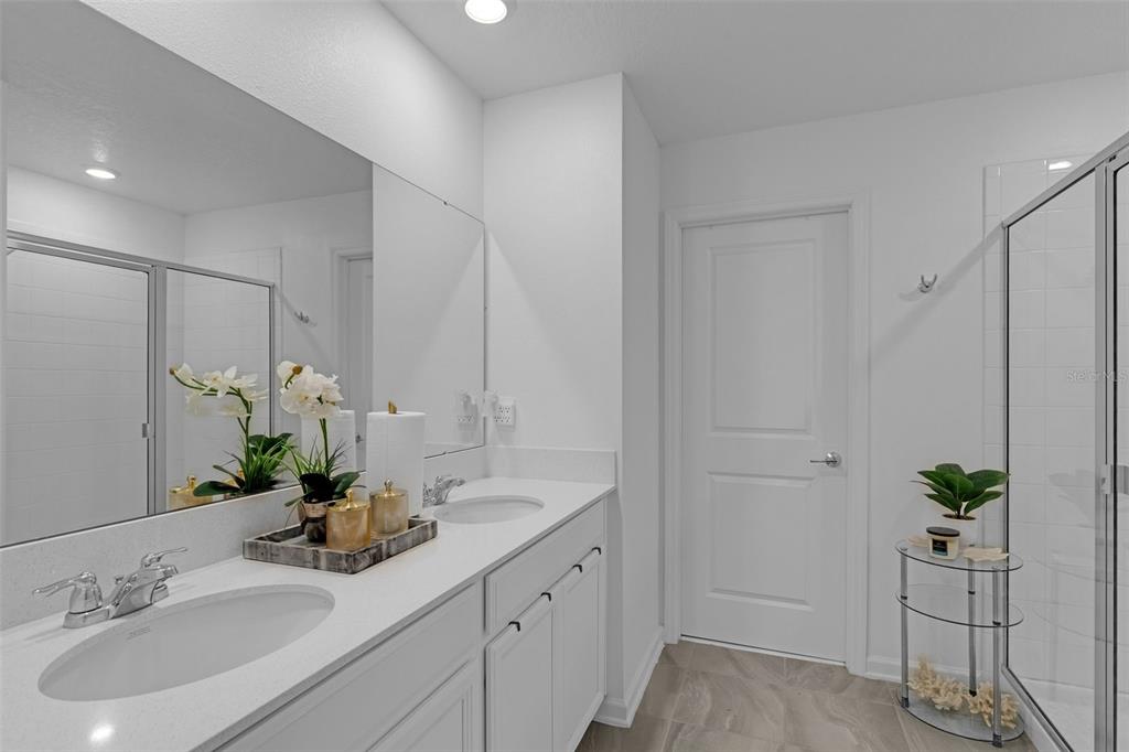 34535 Shellback Street Leesburg, FL 34788 - Photo 32 of 36 a bathroom with a sink a vanity and a mirror