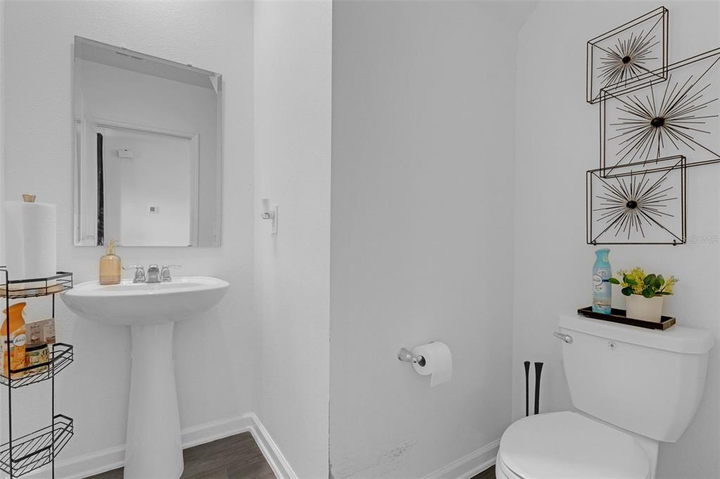 34535 Shellback Street Leesburg, FL 34788 - Photo 33 of 36 a bathroom with a sink a toilet and mirror