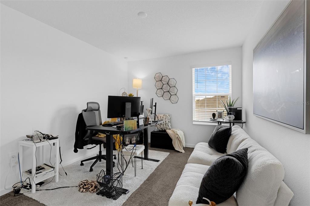 34535 Shellback Street Leesburg, FL 34788 - Photo 35 of 36 a view of a workspace with furniture and a window