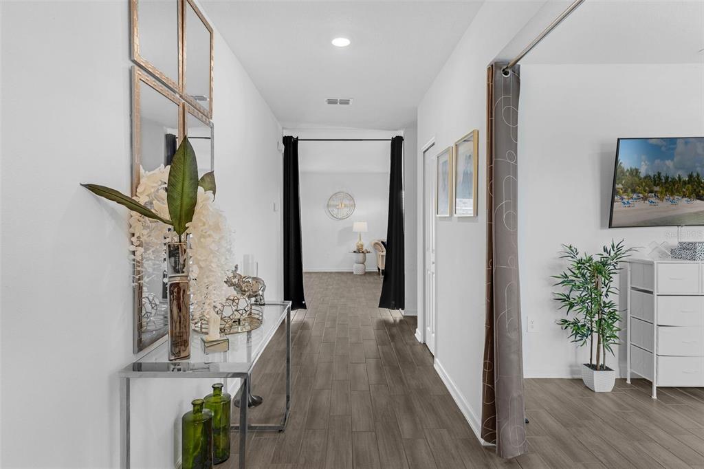 34535 Shellback Street Leesburg, FL 34788 - Photo 5 of 36 a view of a hallway with wooden floor and front door