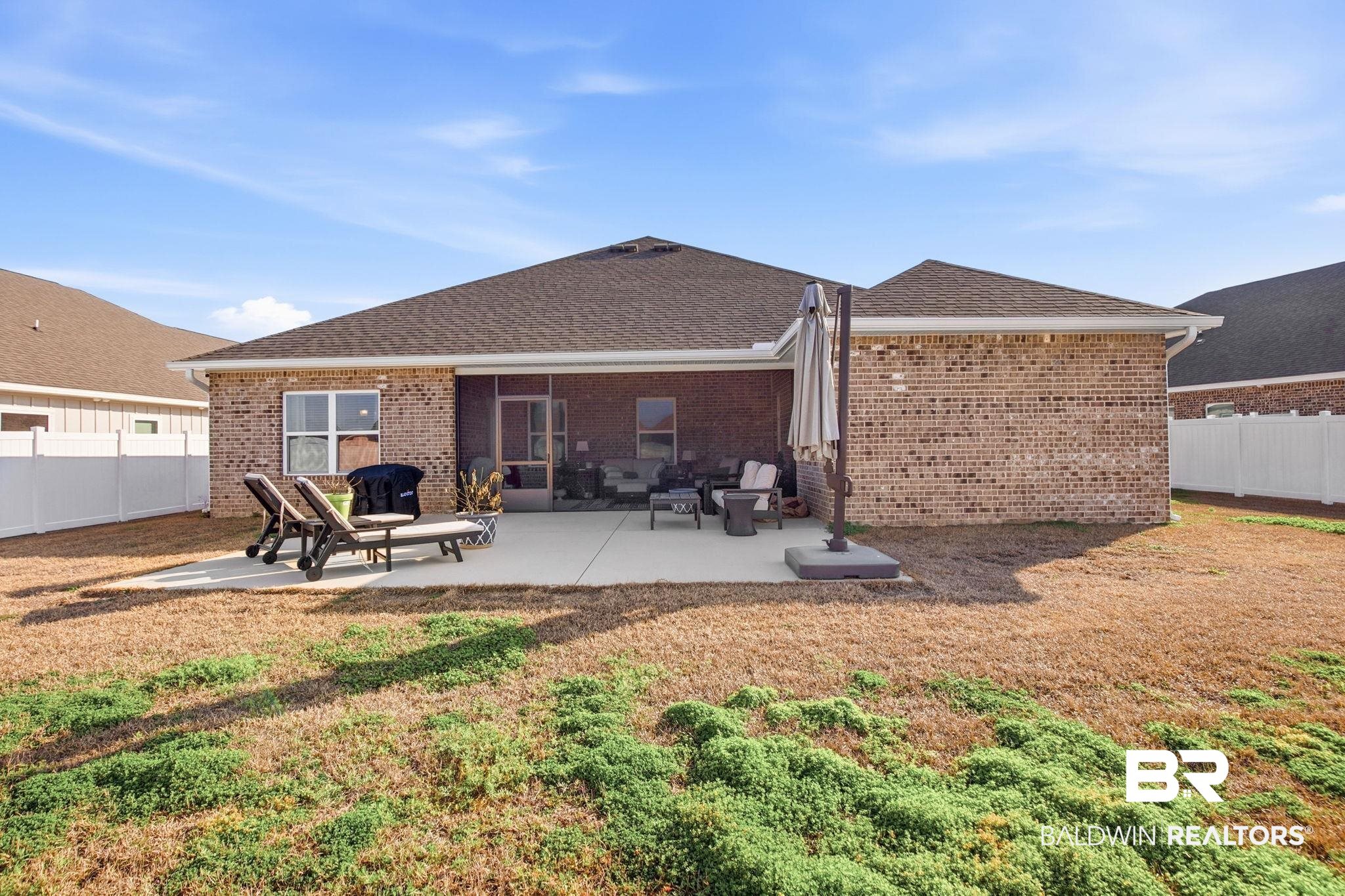 11123 Genuine Risk Circle Daphne, AL 36526 - Photo 47 of 67 Back of property featuring a fenced backyard, a patio, brick siding, and roof with shingles