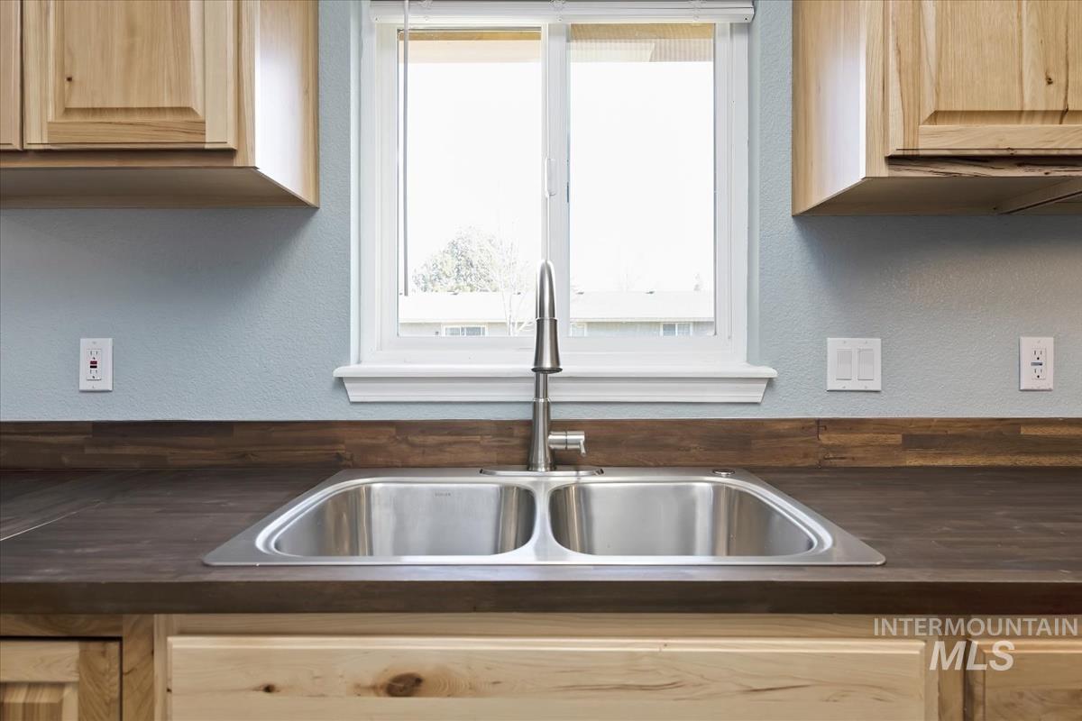 7091 West Limelight Street Boise, ID 83714 - Photo 11 of 34 Kitchen with a textured wall, light wood finish cabinetry, and butcher block counters