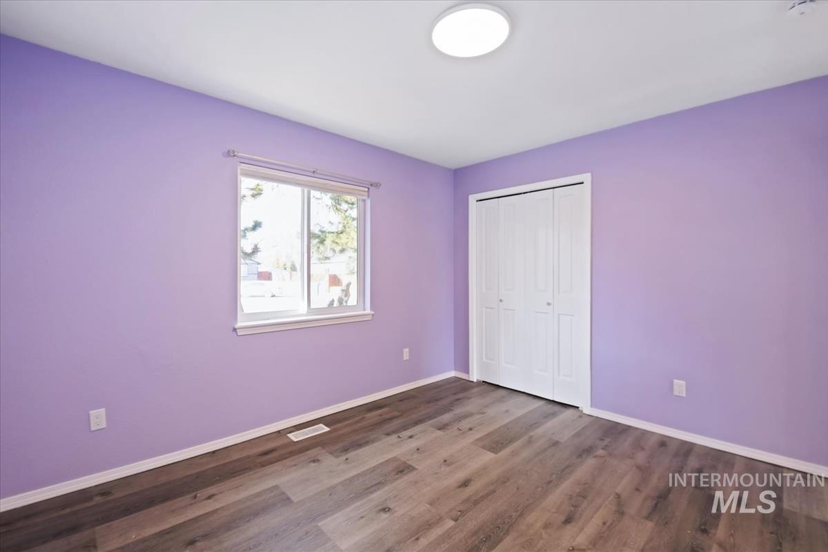 7091 West Limelight Street Boise, ID 83714 - Photo 16 of 34 Unfurnished bedroom featuring a closet and dark wood-type flooring