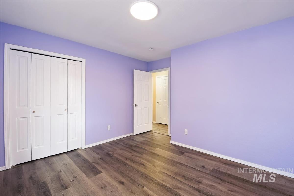 7091 West Limelight Street Boise, ID 83714 - Photo 17 of 34 Unfurnished bedroom with a closet and dark wood-style flooring