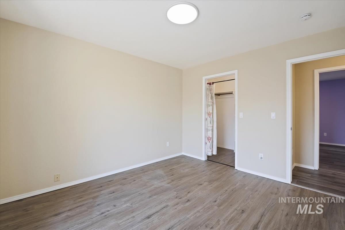7091 West Limelight Street Boise, ID 83714 - Photo 22 of 34 Unfurnished bedroom featuring wood finished floors and baseboards
