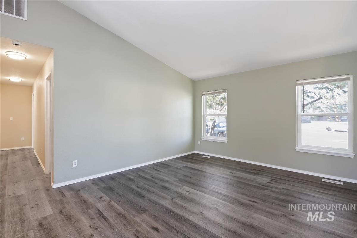 7091 West Limelight Street Boise, ID 83714 - Photo 7 of 34 Empty room featuring lofted ceiling and dark wood-style floors