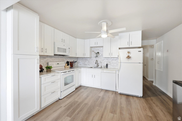 215 Carol Way Midvale, UT 84047 - Photo 10 of 30 Kitchen featuring white appliances, light countertops, and white cabinetry