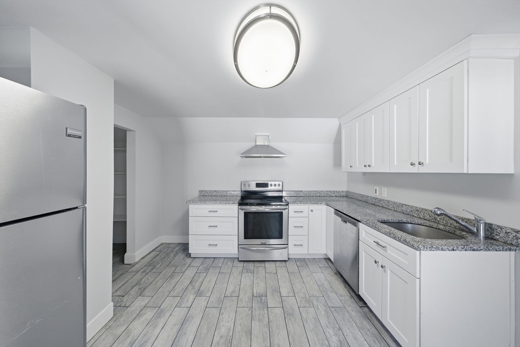 a kitchen with a white cabinets and white appliances
