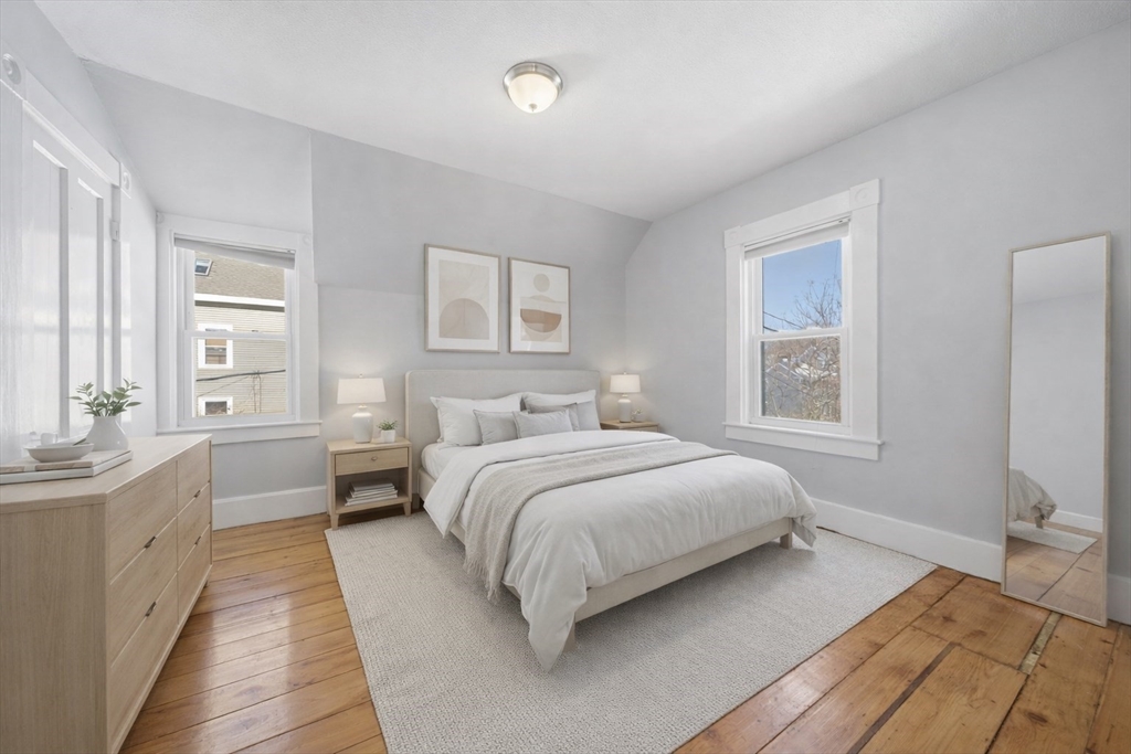 20 Wilson Street, Unit 2 Natick, MA 01760 - Photo 7 of 11 a bedroom with a bed and a large window
