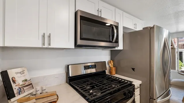 a view of kitchen with furniture and wooden floor