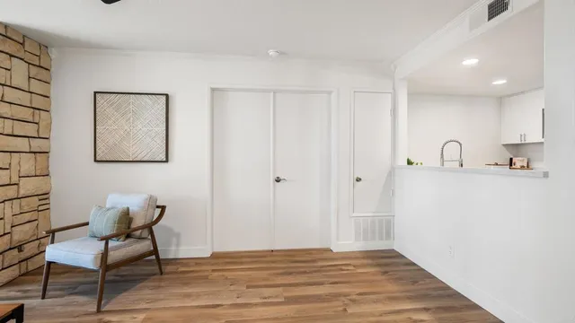 a hallway with chairs and wooden floor