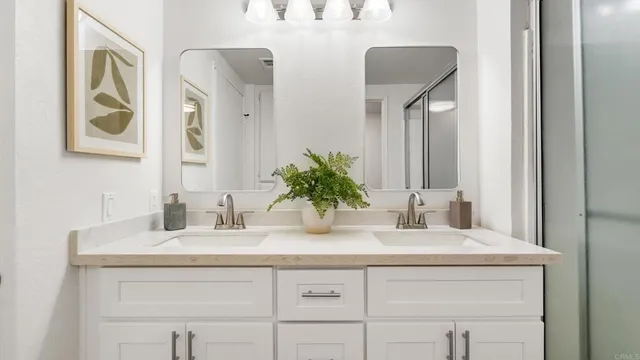 a bedroom with a bed and a lamp on the dresser