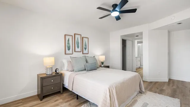 a bedroom with a bed and mirror