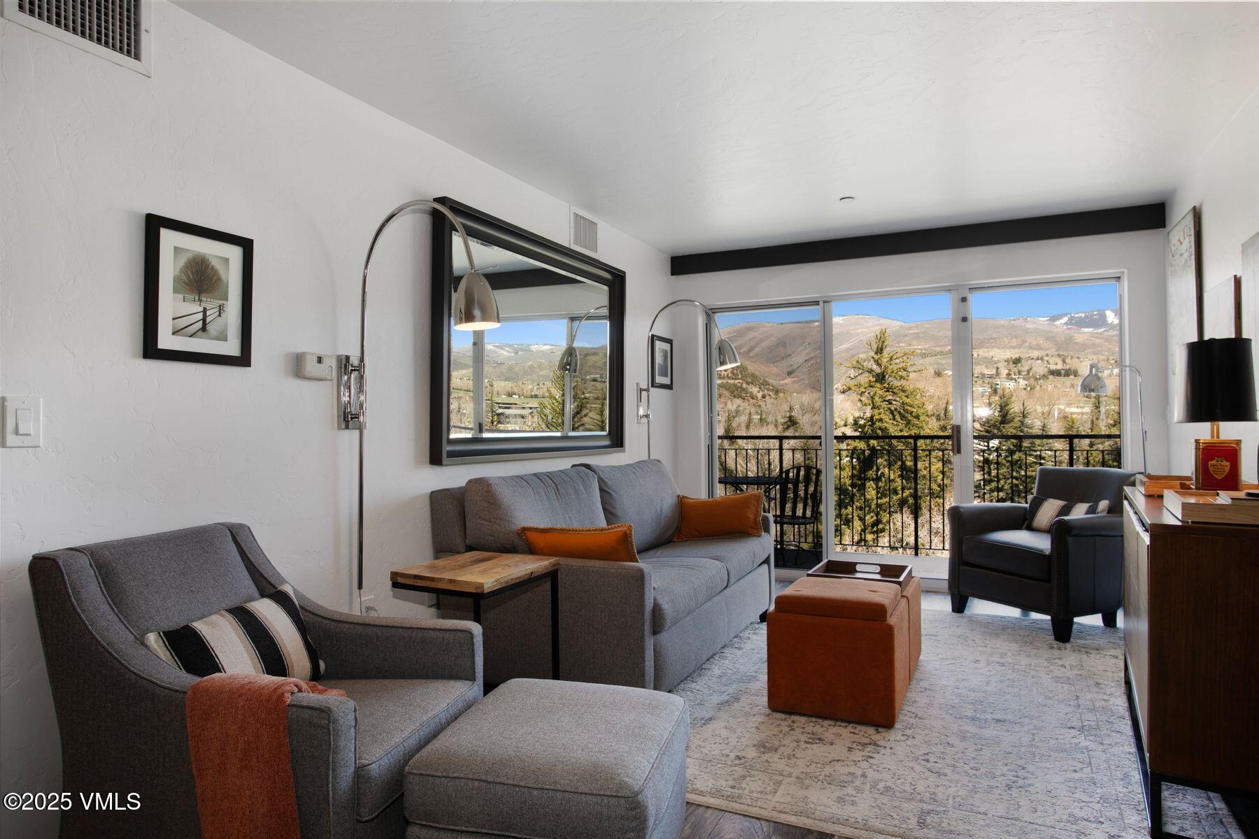 97 Main Street, Unit 304 Edwards, CO 81632 - Photo 11 of 31 a living room with furniture and a floor to ceiling window