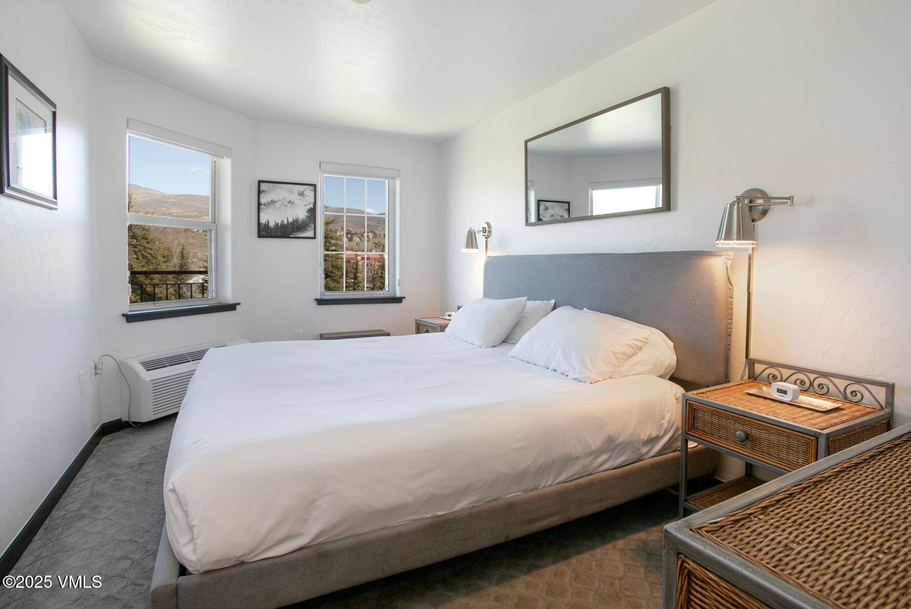 97 Main Street, Unit 304 Edwards, CO 81632 - Photo 13 of 31 a bedroom with a bed and wooden floor