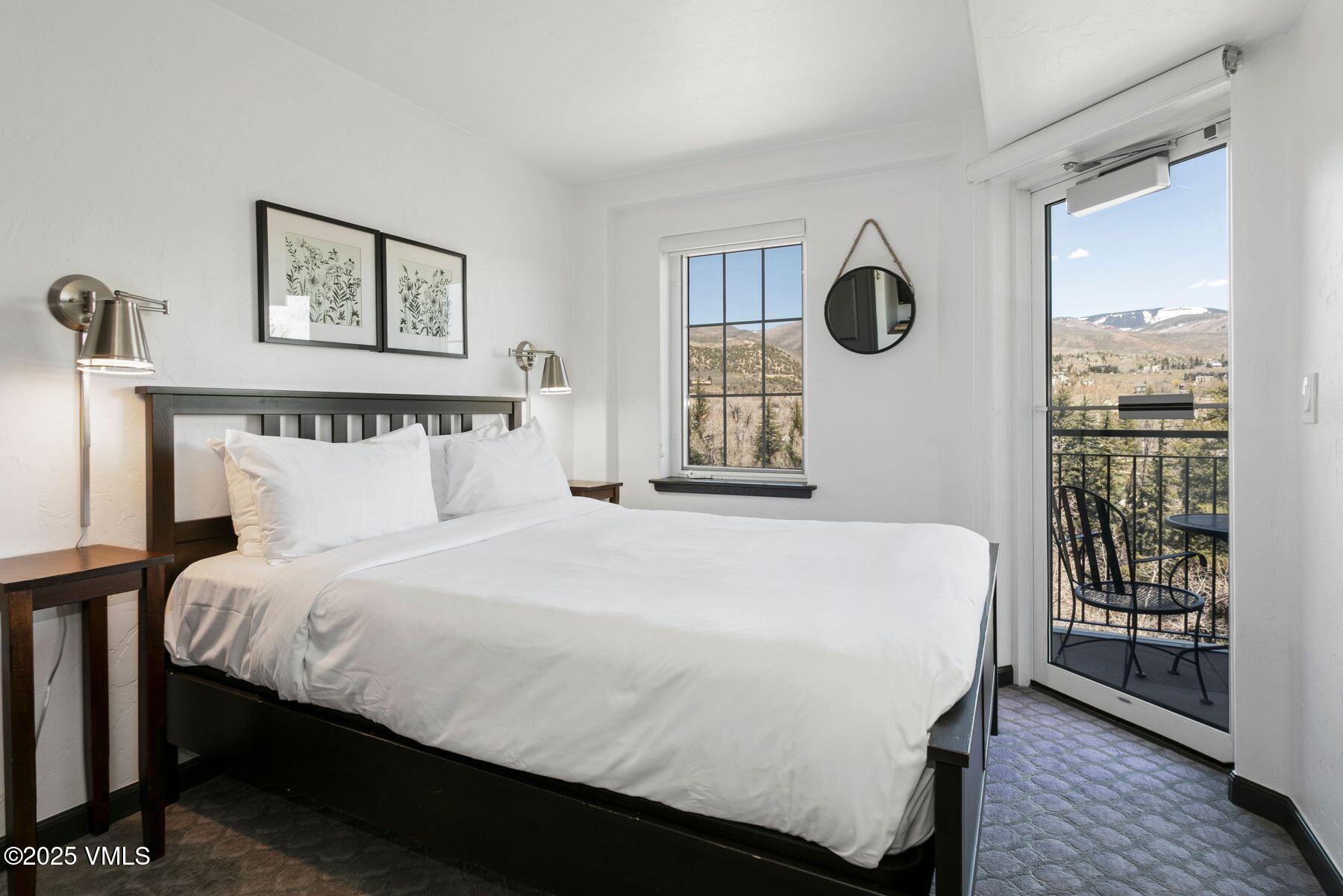 97 Main Street, Unit 304 Edwards, CO 81632 - Photo 16 of 31 a bedroom with a large bed and a window