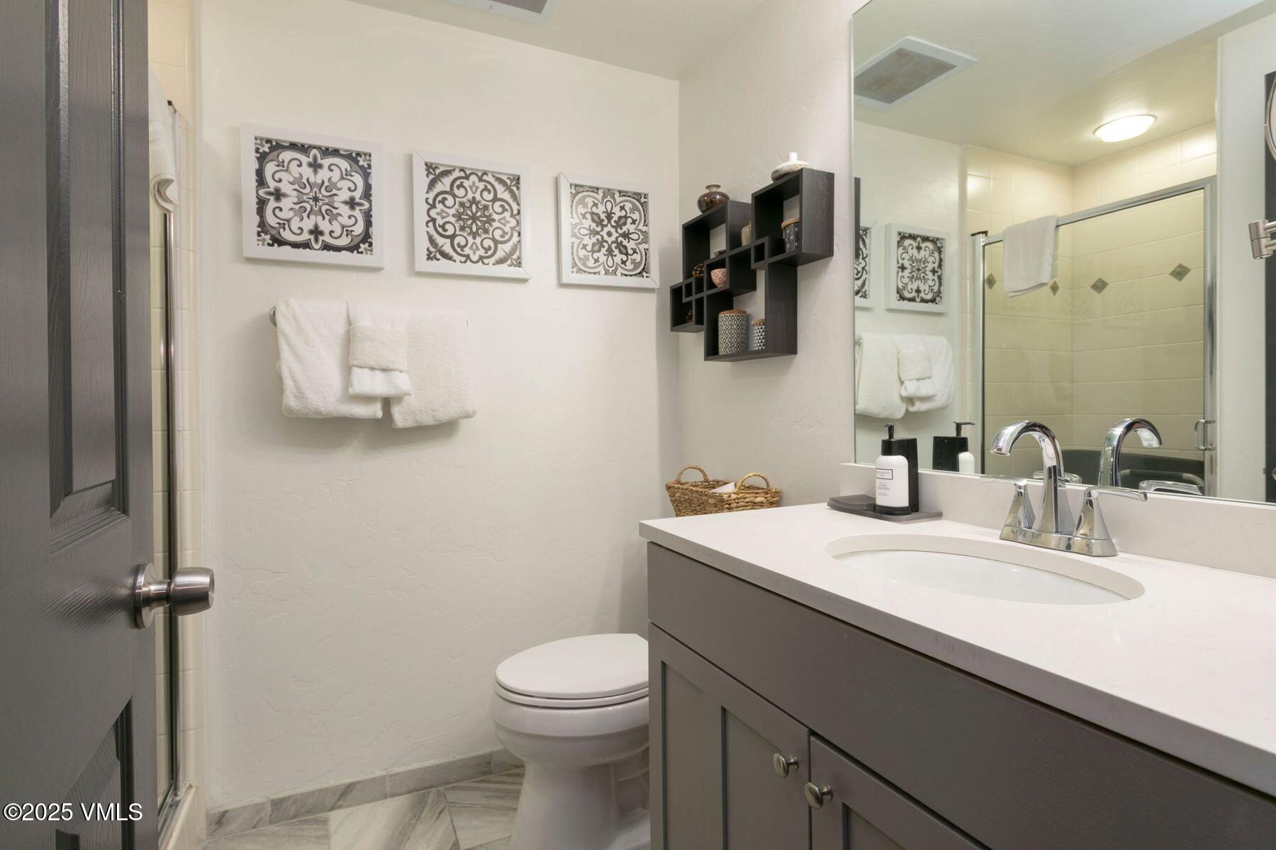 97 Main Street, Unit 304 Edwards, CO 81632 - Photo 19 of 31 a bathroom with a sink vanity mirror and toilet