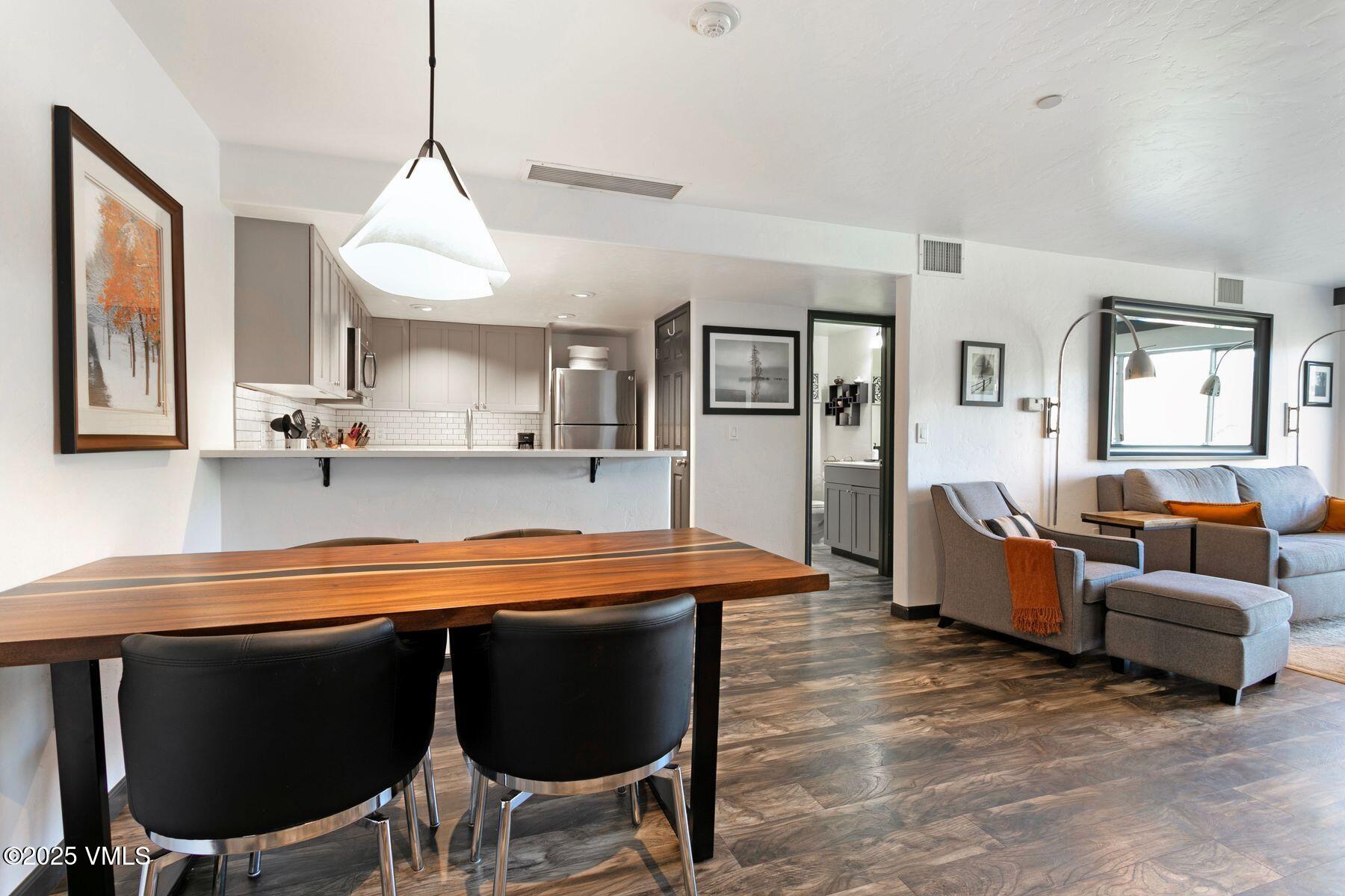 97 Main Street, Unit 304 Edwards, CO 81632 - Photo 7 of 31 a large kitchen with a table and chairs