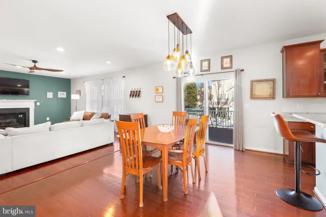 a living room with furniture and view of kitchen