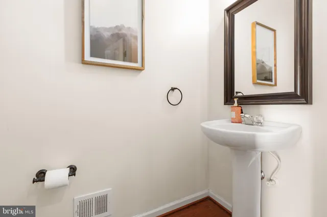 a bedroom with a large bed a flat tv screen and a large window