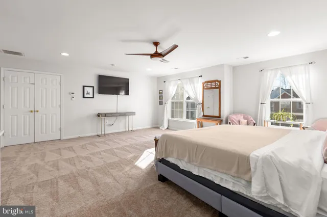a spacious bathroom with a granite countertop sink mirror and bathtub
