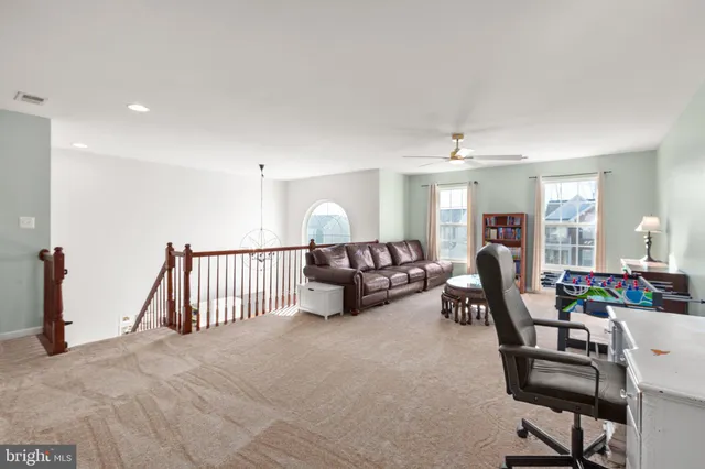 a view of a livingroom with furniture and a ceiling fan