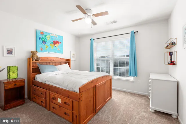 a bedroom with bed and a flat screen tv